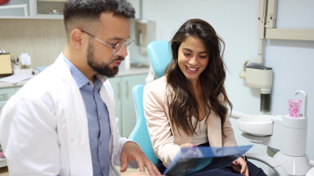 Dentist discussing a dental model with a patient