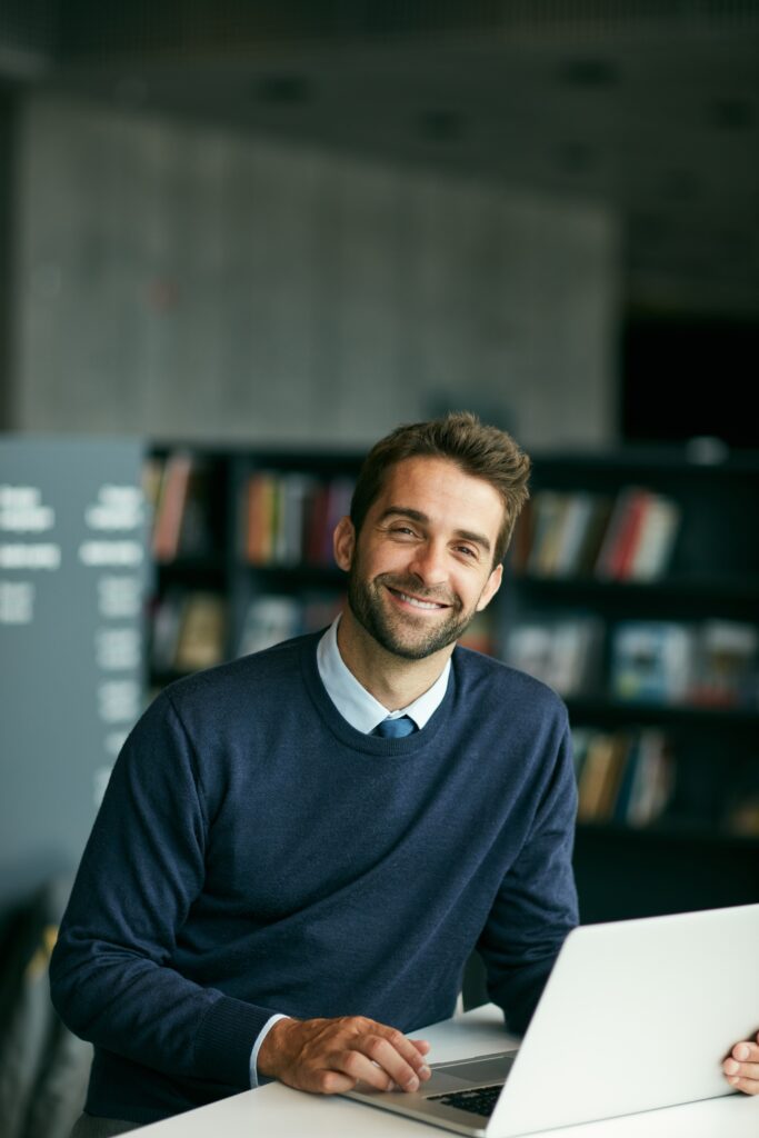 Smiling man seated indoors